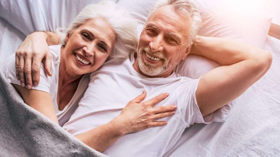 Happy Older Couple in Bed